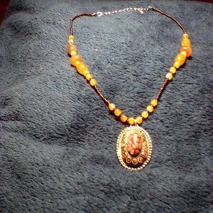 Pretty browns, orange, gold, and bronze colored bead necklace.